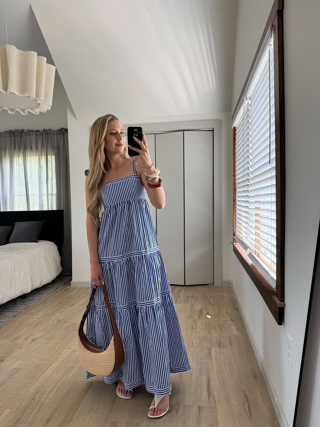 Nautical vibes. This blue and white striped tiered maxi dress is a summer essential, paired with a straw crescent bag and white sandals. #MaxiDress #SummerFashion #LTKholiday 

 #LTKgrwm #LTKootd #LTKSaleAlert