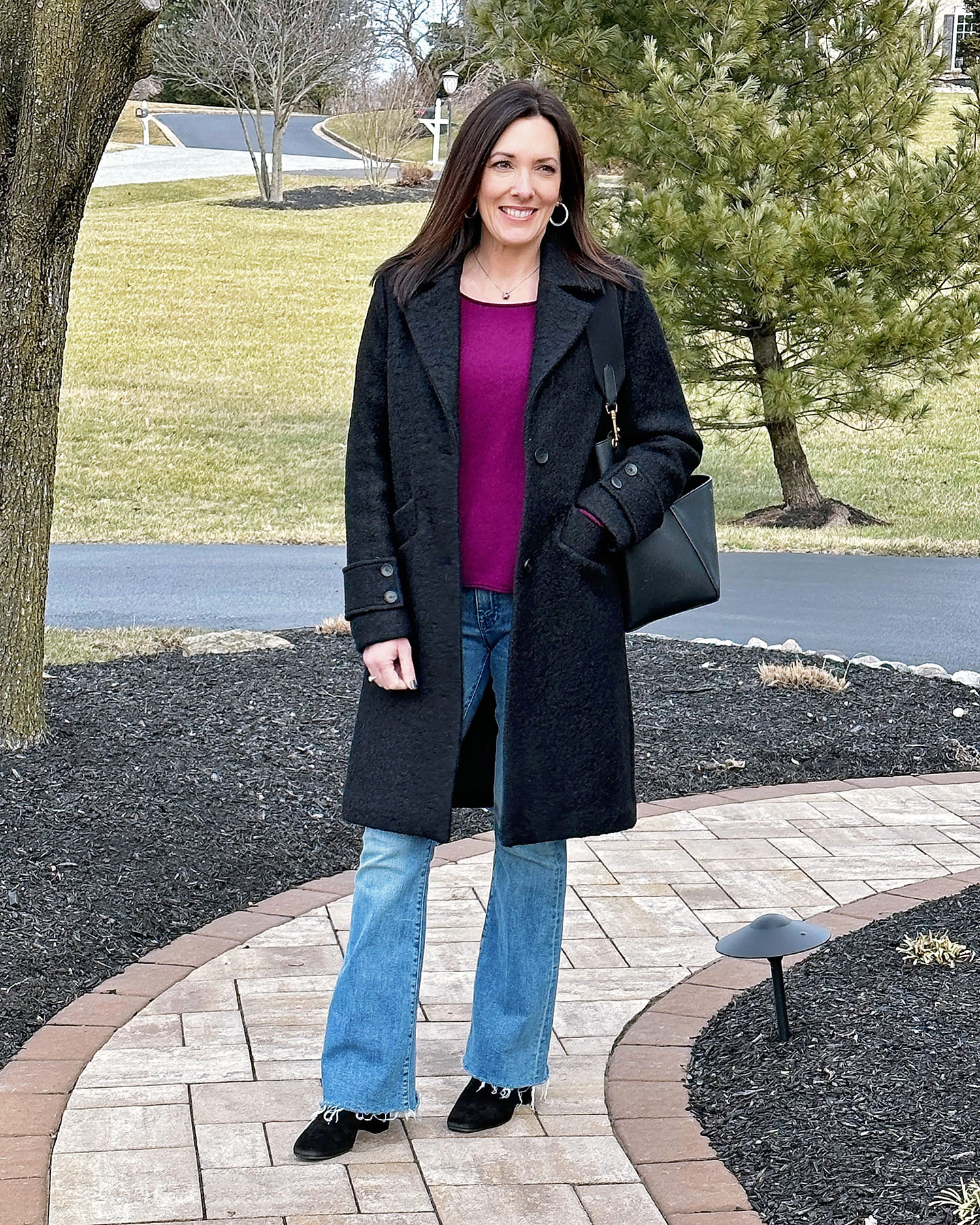 Layering done right: a black wool coat over a boysenberry sweater with flared jeans and black accessories keeps it chic and modern. 

 #LTKSeasonal #LTKOver40