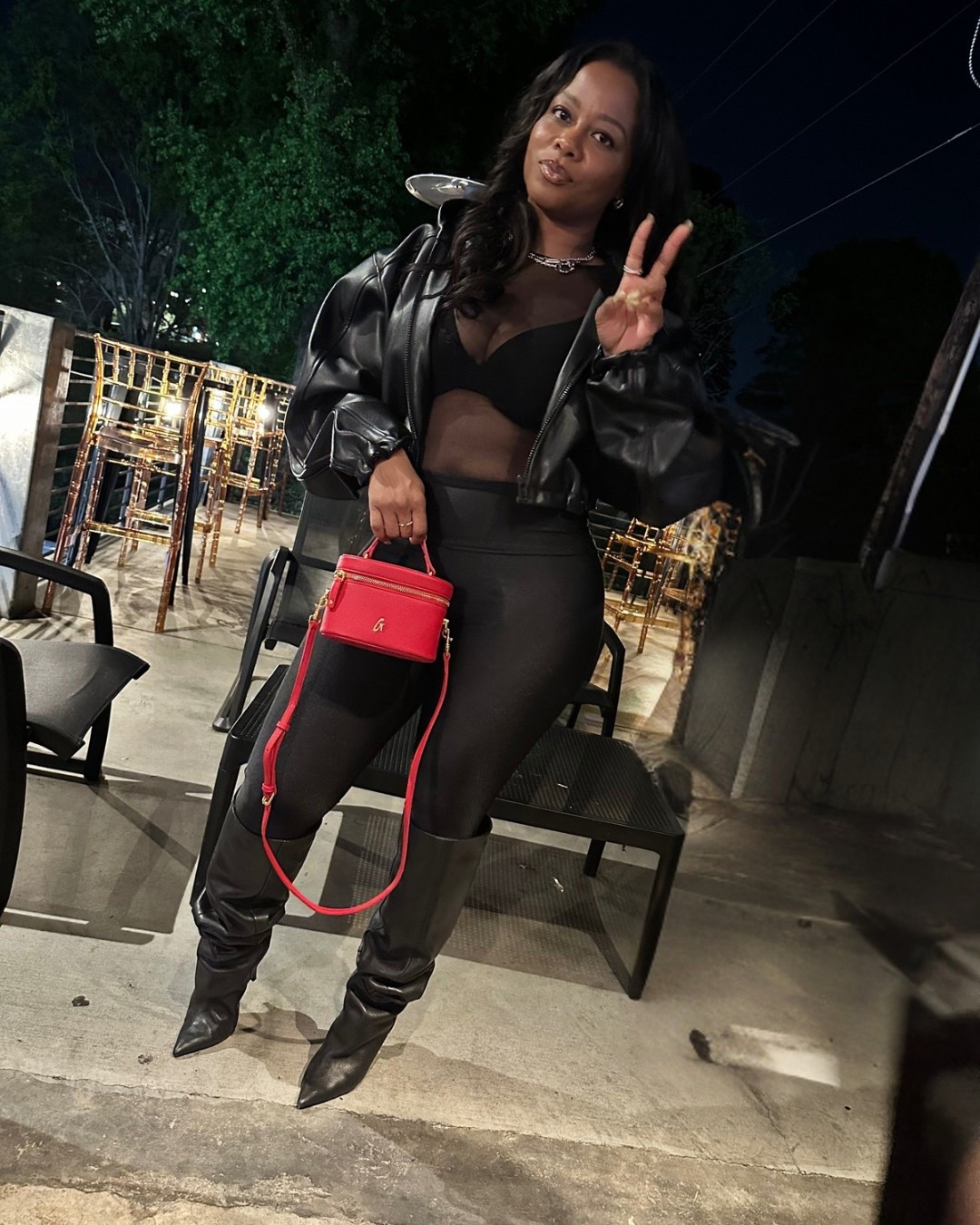 Friday night vibes in all black with a pop of red. 