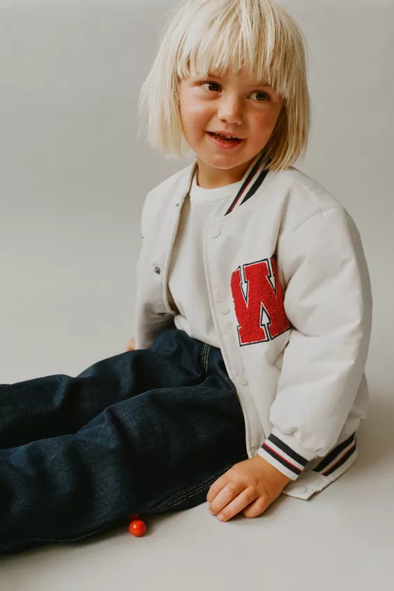 Varsity bomber jacket with stand-up collar and long sleeves with cuffs. Front snap-button closure... | Zara US