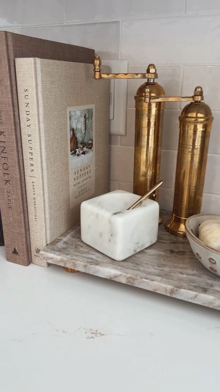 Kitchen Counter Styling
This is my newly styled kitchen tray and books. I love all the different textures this adds to my kitchen. 
The brass mills, marble tray, linen books, and the planter bring so much warmth to my white kitchen  

#LTKfindsunder50 #LTKhome #LTKstyletip