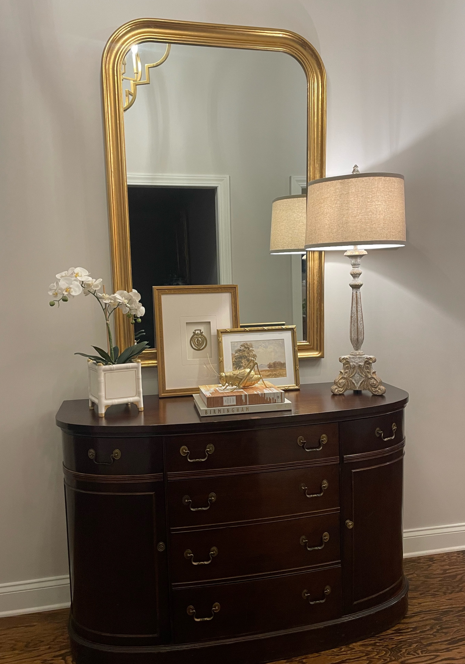 Shop my entry way vignette - entryway, orchid, gold mirror, gold frames, stacked books, gold grasshopper, home decor

#LTKFind 

#LTKGiftGuide #LTKhome #LTKfindsunder50