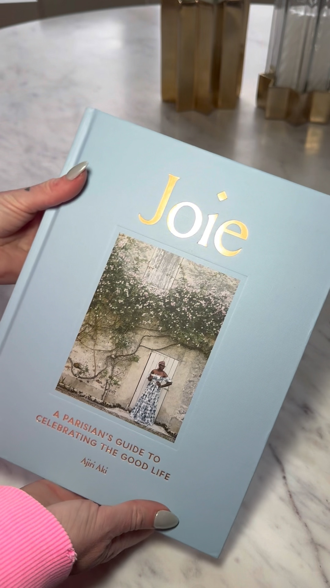 Hour a French guide to happiness, Parisian style lifestyle, books, coffee, table, books, and bookcase decor about Paris, France