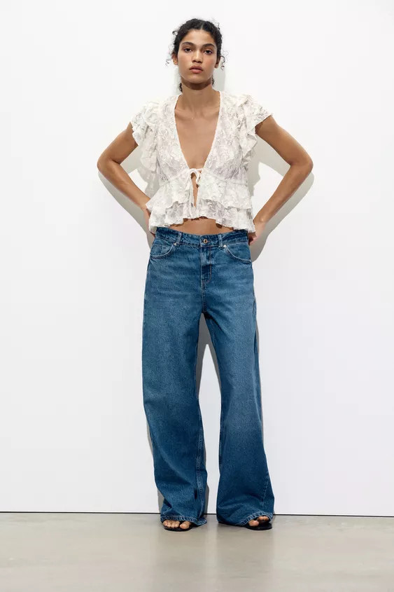 Lace top with a V-neck and short sleeves. Ruffle detail in the same fabric. Front lace-up closure... | Zara US