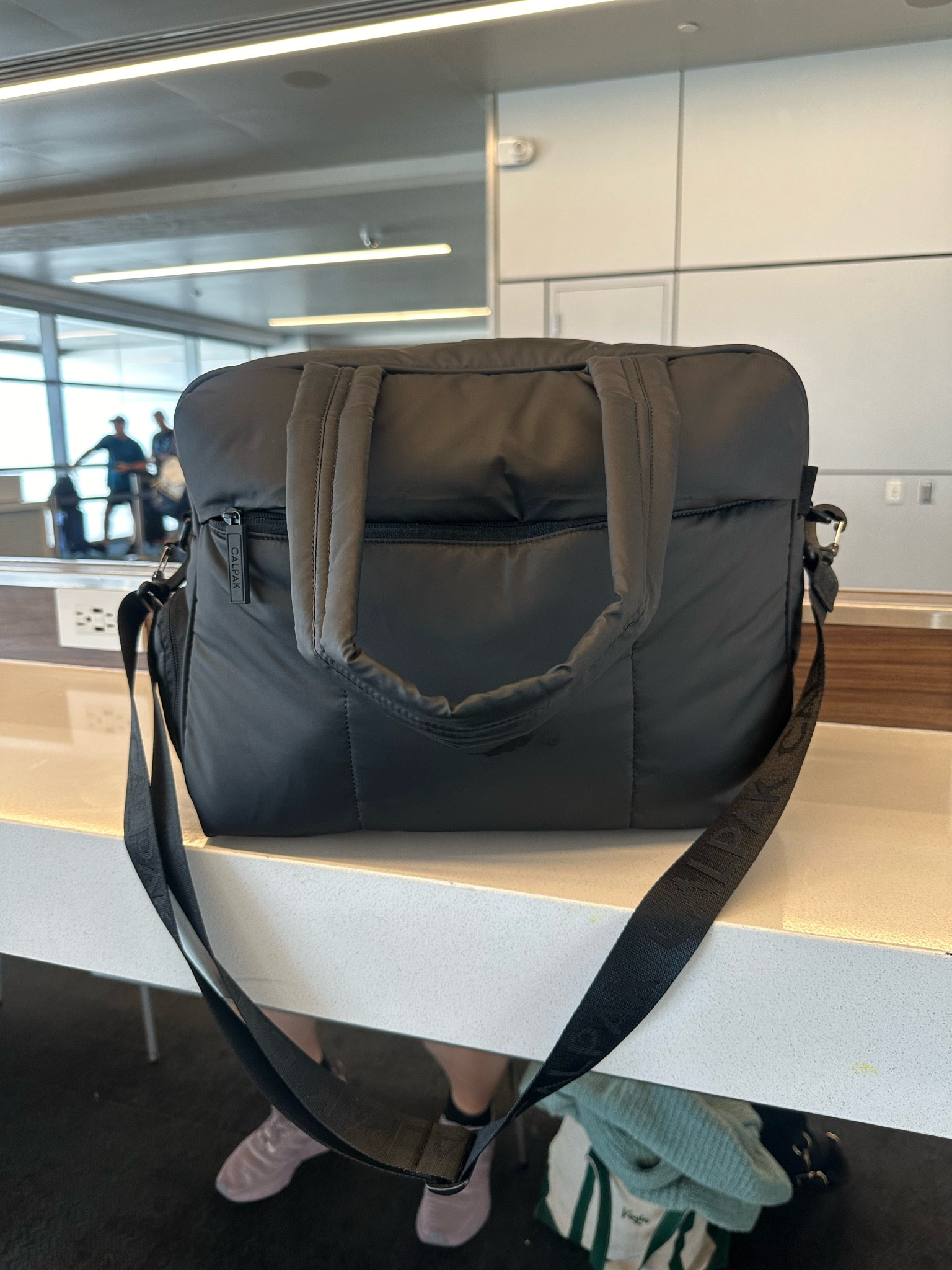 10000/10 recommend for international travel 🧳 I was able to fit 4 toiletry bags, 2 pairs of shoes, a book, hairbrush, three purses, all my tech, passports, wallet + a couple more things!