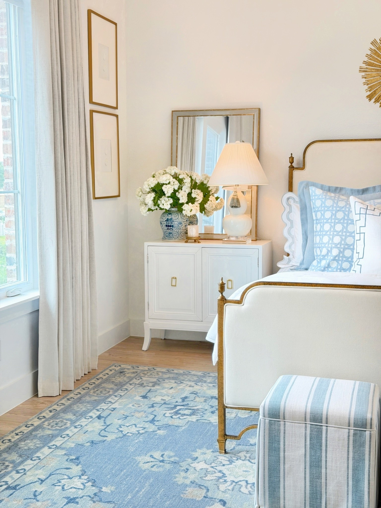 Summer bedroom styling, blue rug, upholstered bed frame, cane print pillow, euro shams s slipped sham