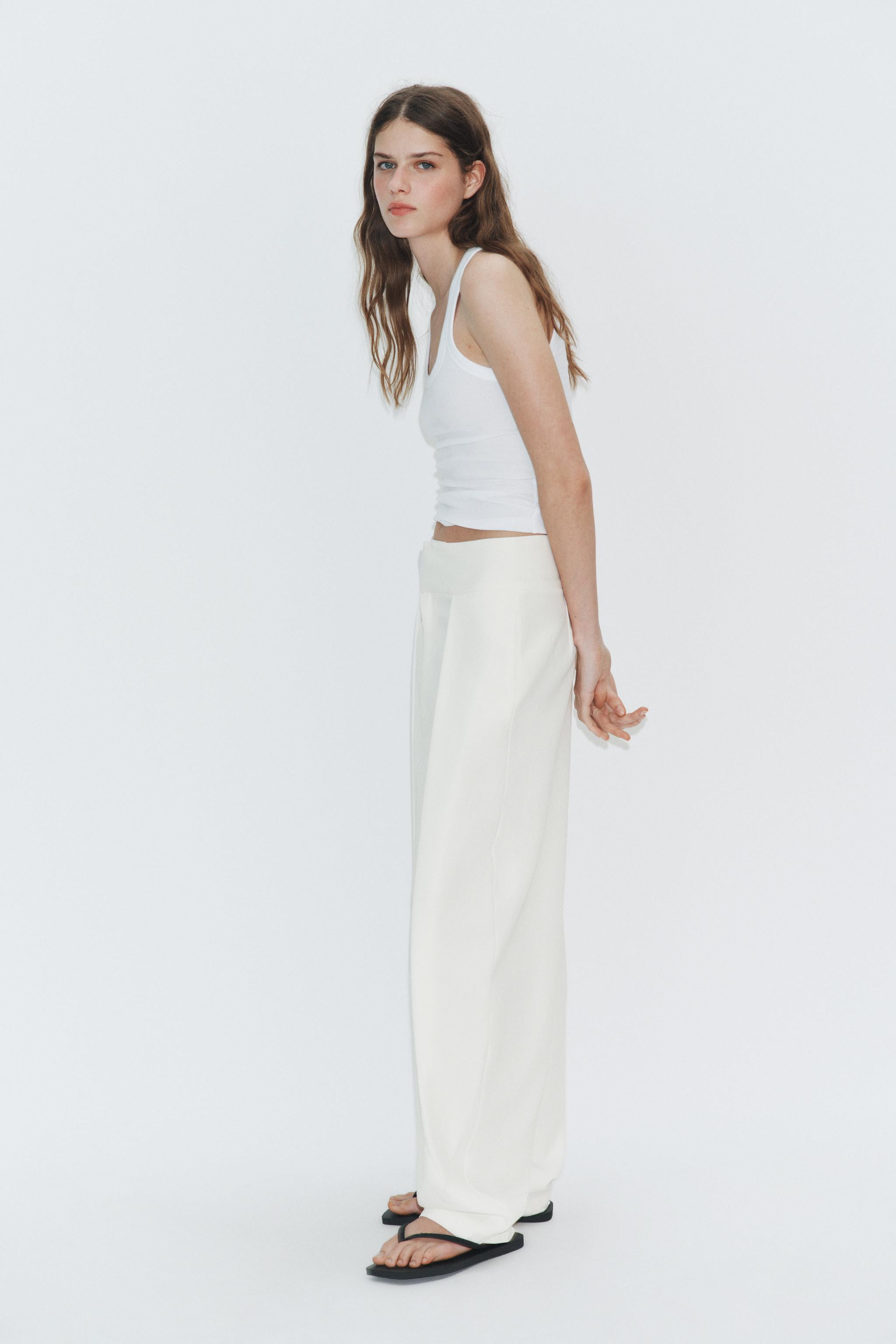 High-waisted pants made from a 24% linen blend yarn. Front pleats. Concealed side seam pockets. F... | Zara US