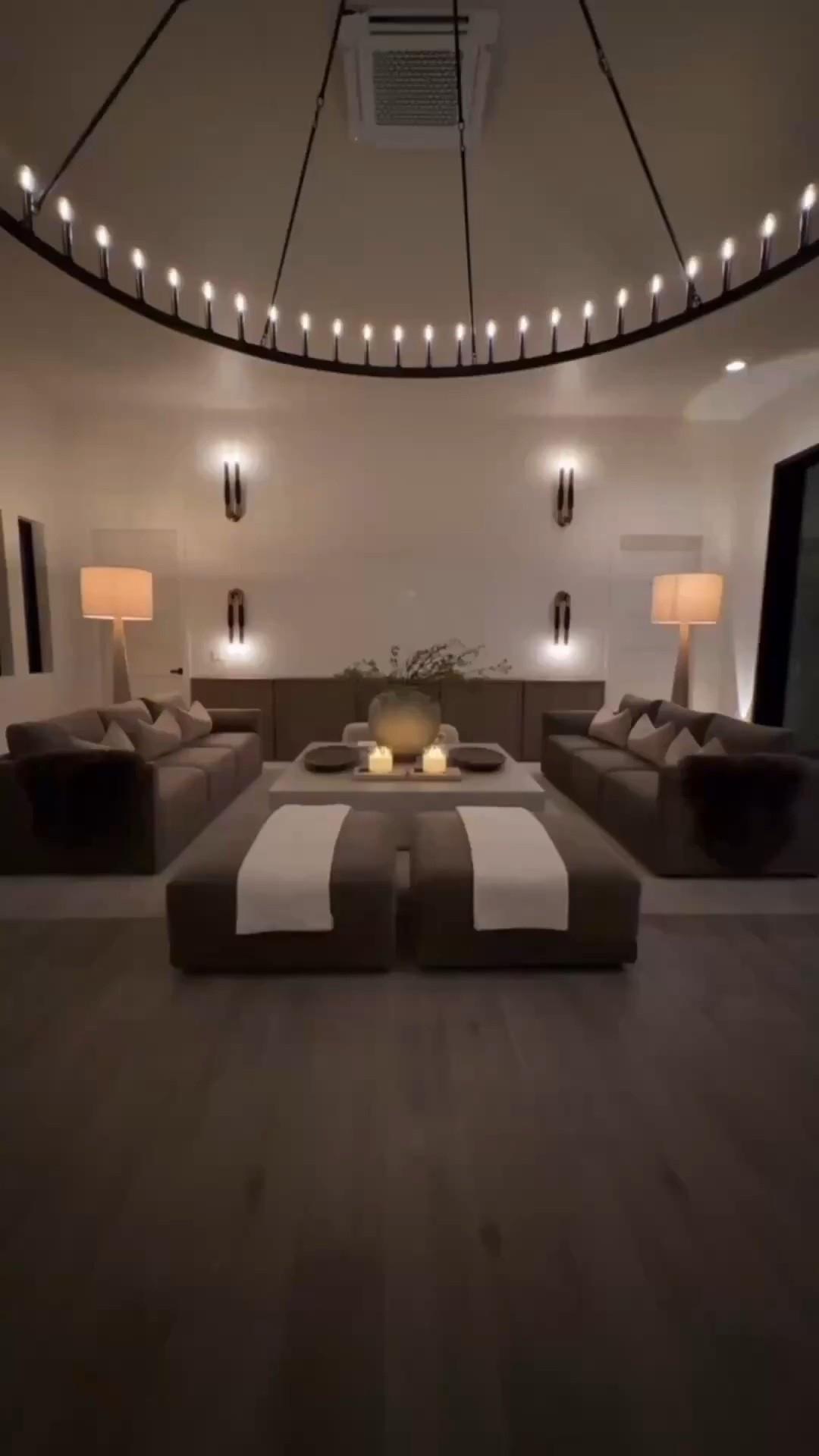 Moody, modern, and effortlessly cozy 🤎 This living room design brings together oversized chandeliers, a luxe velvet couch, matching ottomans with layered throw blankets, and a stunning concrete coffee table for the perfect elevated vibe. The wall sconces and floor lamps add that warm ambient glow that makes the whole space feel curated and high‑end. A dreamy mix of texture, lighting, and timeless style.


#livingroominspo #moodylivingroom #modernhomedecor #velvetcouch #coffeetablestyling #neutralhomestyle #interiorstyling #homedecorfinds #ltkhome #cozylivingroom #ambientlighting


#LTKdayinmylife #LTKHome #LTKvlog