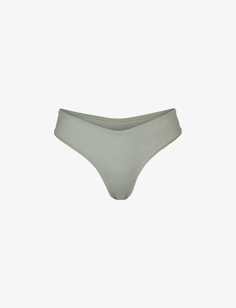 SKIMS Dipped mid-rise stretch-cotton thong | Selfridges