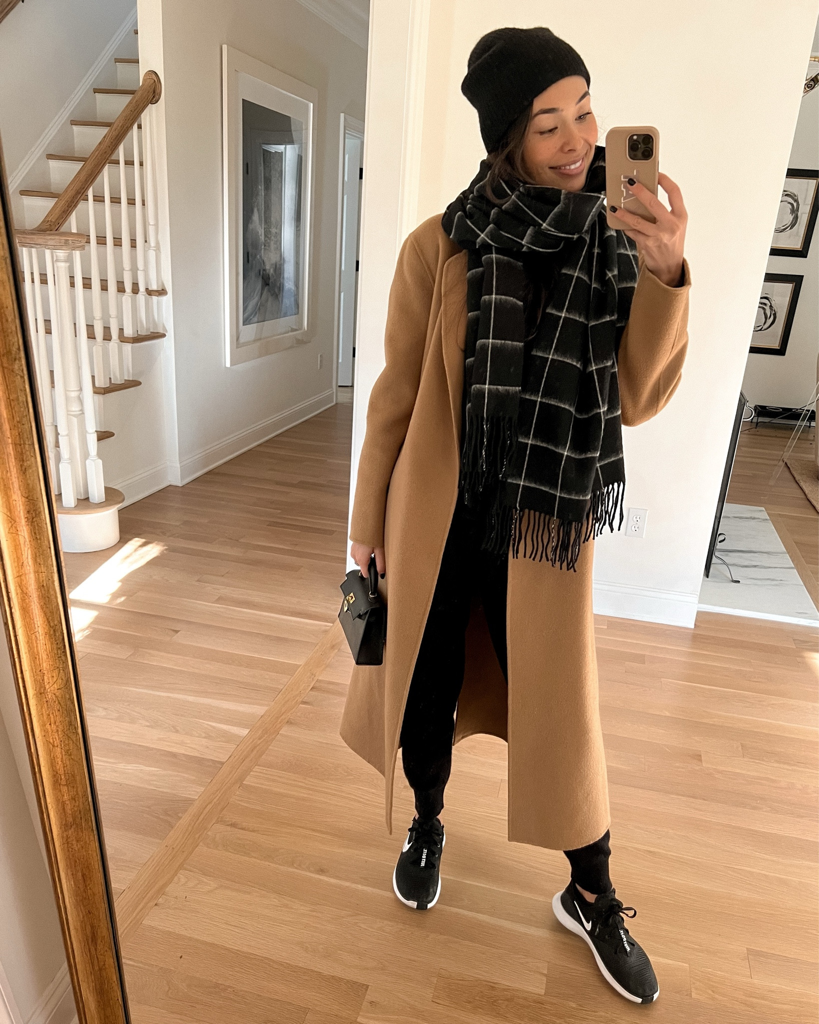 Kat Jamieson wears a camel coat and plaid scarf. Cashmere beanie, winter coat, winter outfit, sneaker style. 

#LTKitbag #LTKSeasonal #LTKshoecrush