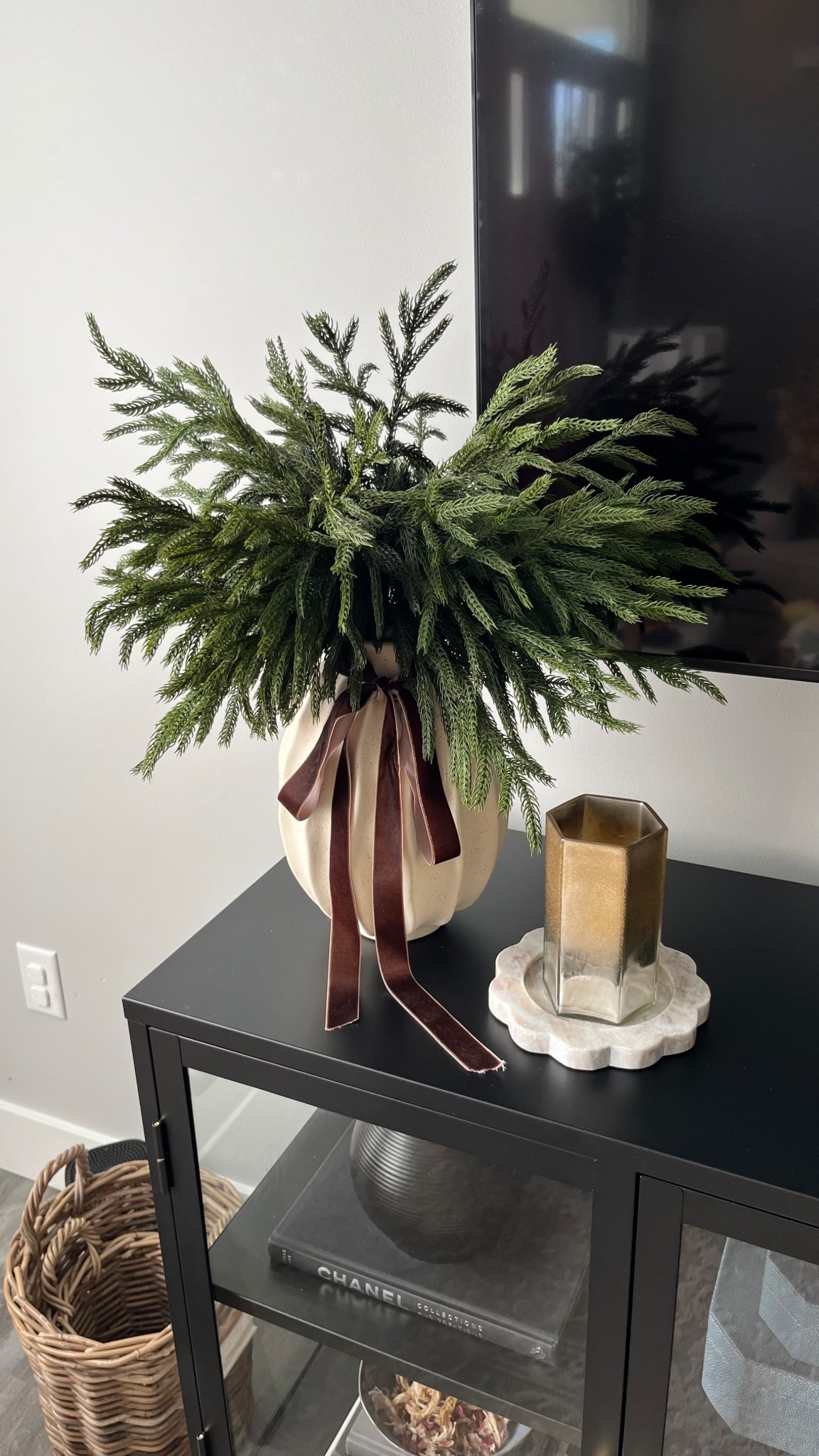 Christmas decor on our tv stand: Christmas droopy pine branches faux stems, brown velvet ribbon, cream wavy vase, marble scalloped candle tray, candle.

Home decor, home style, holiday decorr

#LTKSeasonal #LTKHoliday #LTKHome