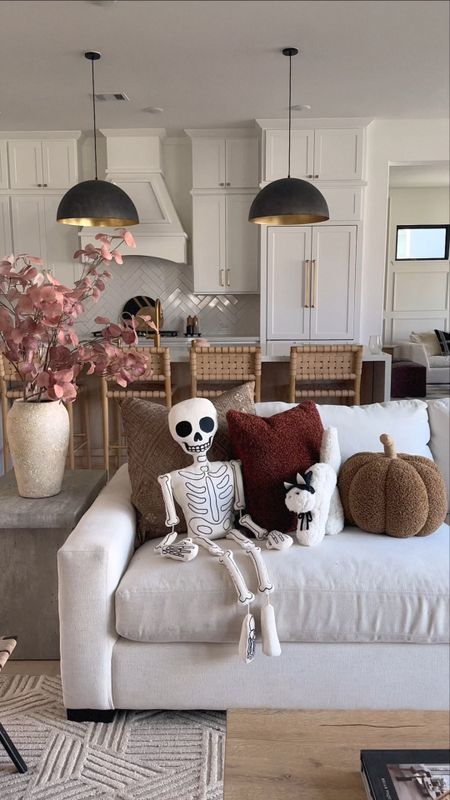 Our living room decorated for the fall! These are the Potterybarn skeleton, ghost, and pumpkin pillows! They are super soft and sell out fast. 

#LTKhome #LTKunder100 #LTKSeasonal