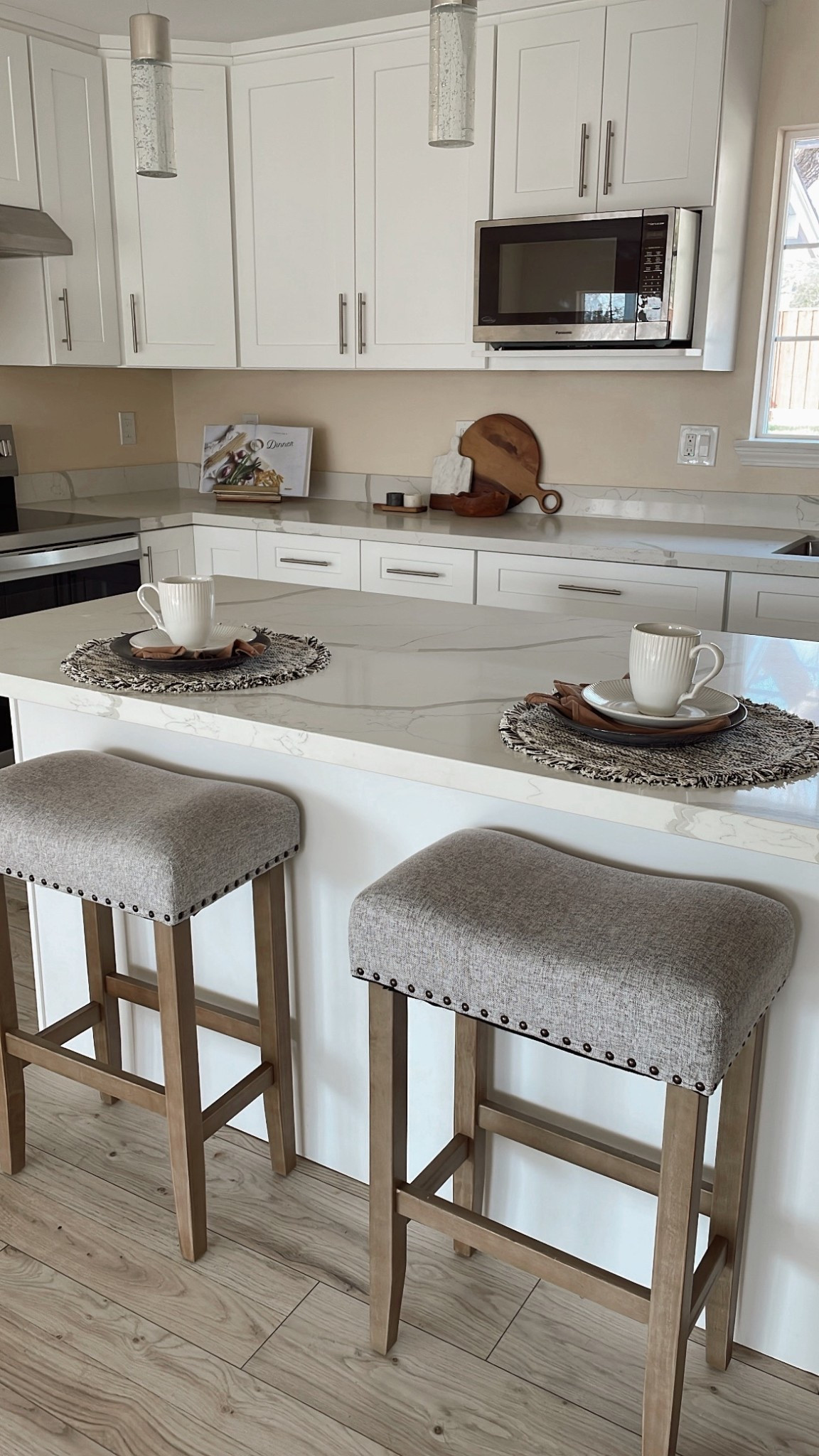 Proof that small details make a big impact 🤍
This staged kitchen is all about warm neutrals, soft textures, and everyday pieces that feel elevated.

✨ Cozy counter stools
✨ Simple place settings
✨ Natural wood accents that instantly warm up a white kitchen

This is the kind of space that makes you want to sit down with coffee and stay awhile — and the best part is you can recreate this look without a full remodel.

I’ve linked similar stools, placemats, dishes, and styling pieces so you can shop the look and bring this vibe home ☕️✨
Tap to shop below ⬇️
#home#kitchen#warmstyle#homestaging

#LTKHome #LTKdayinmylife #LTKFindsUnder100