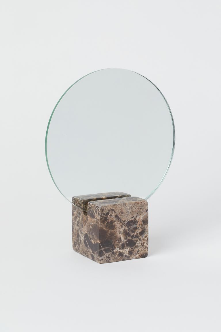 Small, round mirror mounted on a square marble base. Diameter of mirror 7 in. Size of base approx... | H&M (US + CA)