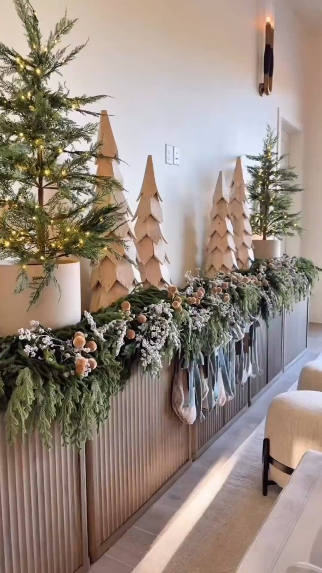 ​​Console table Christmas styling 🎄
I showed one type of garland but ended up mixing two! I added a few simple dried berries, some velvet ornament sticks, customized stocking tags, and ribbon. It was super simple. Hope this gives you a little inspiration for your own setup! 🤎

Hobby Lobby Finds SKU:
Wooden Trees: 6356281
White Berries: 1737360
Ribbon: “Merchant 41: Velvet Trim with fray edge: Color: Arona”

Holiday Styling. Christmas Decor. Mantel Styling. Amazon Christmas. Christmas Garland. 2025 Christmas. Easy Christmas Decor 

#amazonchristmas #christmasdecor 

#LTKHoliday #LTKHome #LTKSeasonal