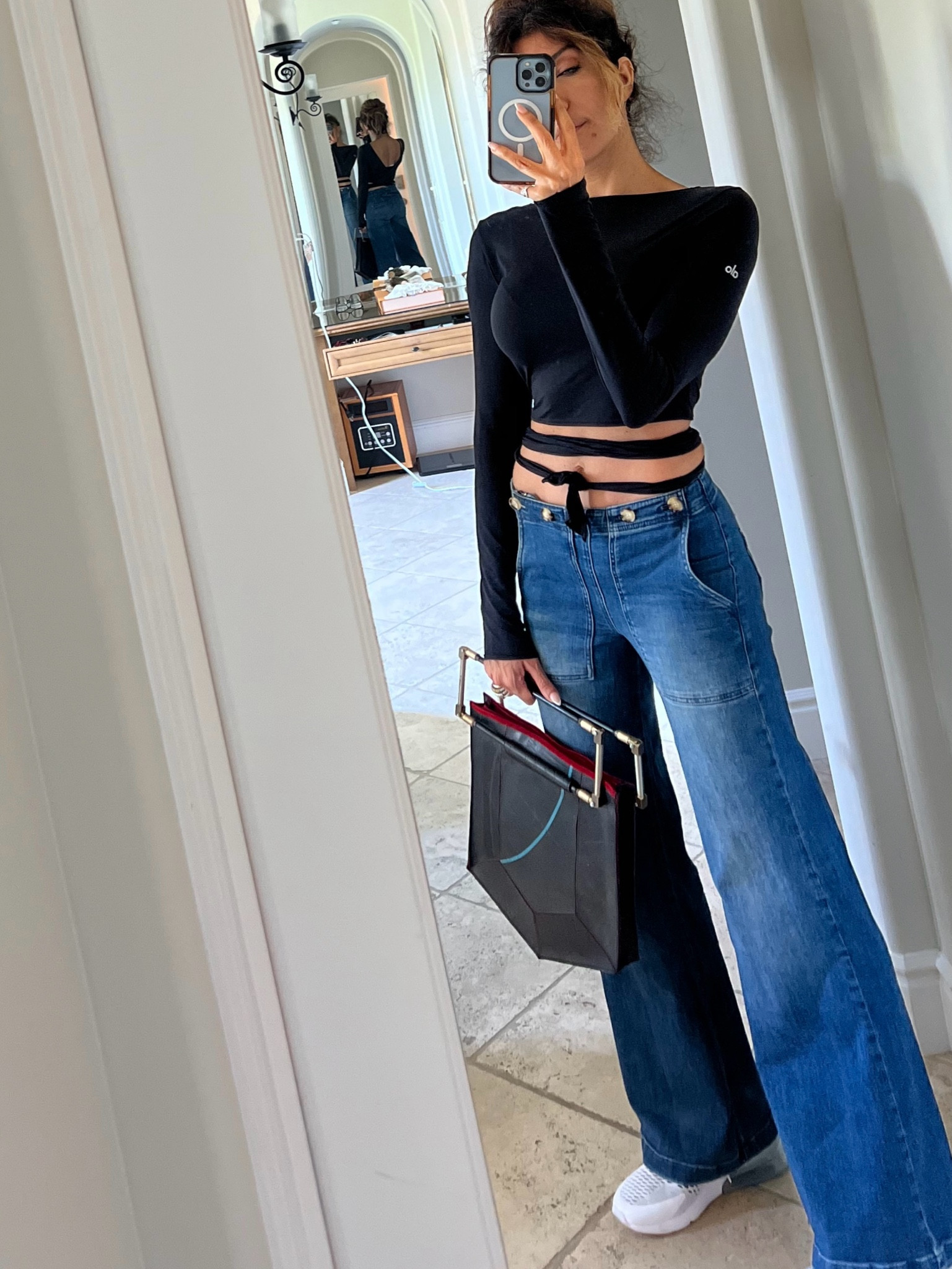 My top is by Alo however, I got it last year and it is no longer available. So I found one identical to it and posted it for you.
Here’s the trick … i wore the back in the front. Totally changes the style and adds a whole lot of edge to the top, 
Wearing size (s) in top 
Size 26 in jeans (I’m typically a size 4-6)