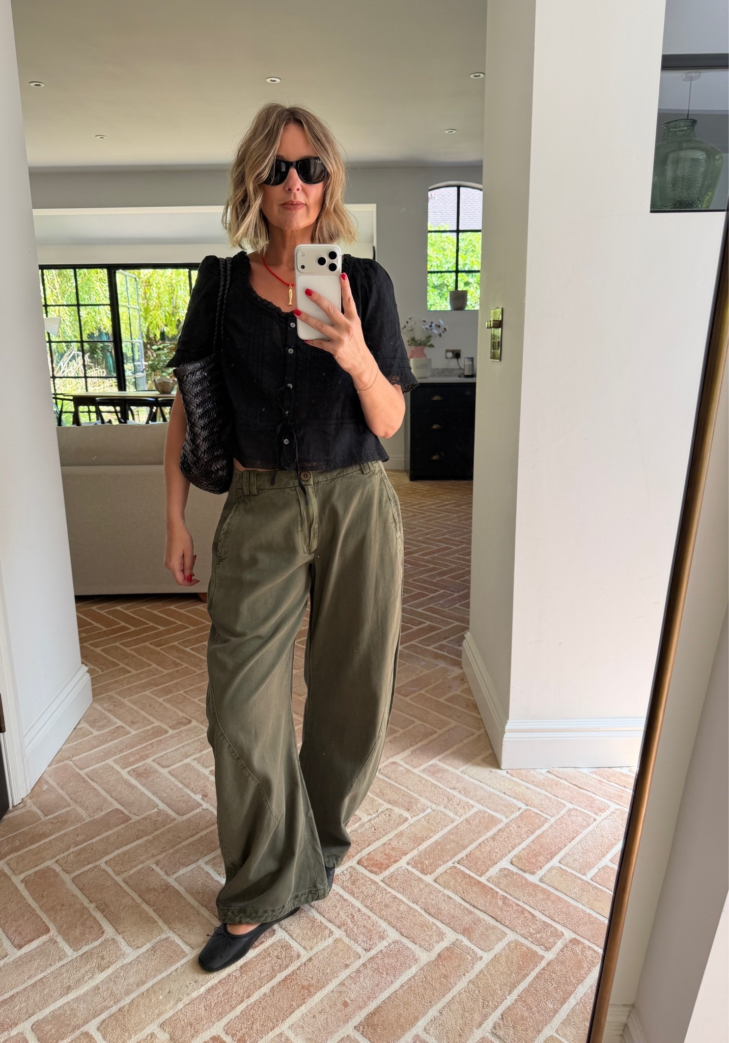 black lace trim blouse, button front top, crochet trim top, khaki cargo trousers, olive wide leg pants, utility trousers, black ballet flats, black woven shoulder bag, gold pendant necklace, black cat eye sunglasses, casual chic outfit, off duty style, autumn transitional dressing, elevated basics, quiet luxury, neutral color palette, monochrome styling, mirror selfie ootd, ltkstyletip

#LTKsummer #LTKfestival #LTKeurope