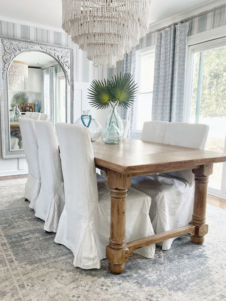 Coastal light and bright dining room, with slip covered dining chairs and coastal curtains

home decor, coastal decor, beach house decor, beach decor, beach style, coastal home, coastal home decor, coastal decorating, coastal interiors, coastal house decor, home accessories decor, coastal accessories, beach style, blue and white home, blue and white decor, neutral home decor, neutral home, natural home decor, serena & lily sale, ryder rug, cooke rug, living room rugs, dining room rugs, coastal rugs, bedroom rugs, end tables, side tables, capiz pendant lights, coffee tables, living room furniture, coastal lighting, white lamps, sheets, woven benches, bath mat, rattan mirrors, round mirrors, striped rugs, blue and white rugs, rattan furniture, beach house furniture, bed pillows, blue & white pillows, pillows on sale, rugs on sale #LTKSale 

#LTKMostLoved #LTKhome #LTKsalealert #LTKstyletip #LTKhome #LTKGiftGuide #LTKfindsunder100 #LTKMostLoved