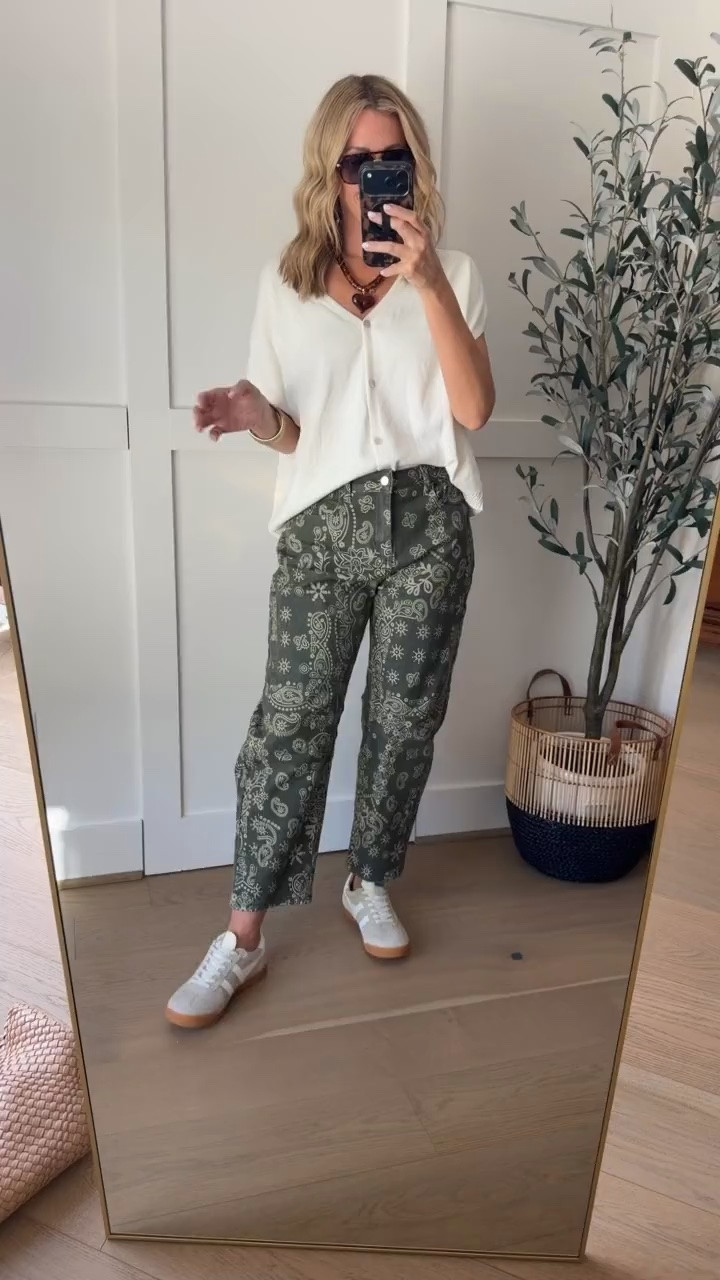 These olive green bandana print pants are such a fun change from everyday denim! I love the relaxed straight leg fit and how the paisley pattern adds interest without being too bold. Paired with a simple ivory button down, layered necklaces, and neutral sneakers, they make a great casual fall outfit.
bandana print pants, olive green pants, paisley print pants, patterned pants, casual fall outfit, straight leg pants, ivory button down, printed pants outfit, sneakers with pants, fall fashion trends, women over 40 fashion, everyday casual style, HauteandHumid