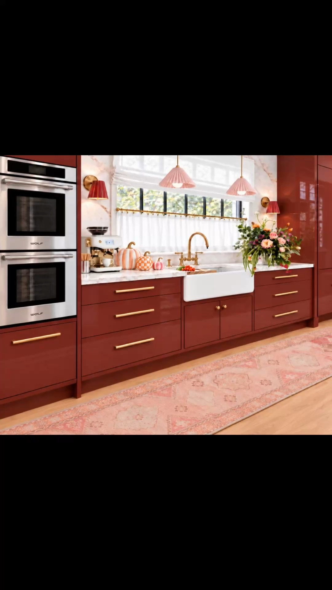 A sweet take on modern chic! ✨💕 A warm, candy-inspired color palette of rich burgundy red, soft blush pink, and crisp white marble brings warmth, personality, and sophistication to this kitchen.

High-gloss cabinetry, a dramatic marble backsplash, waterfall kitchen island, modern farmhouse sink, brass bridge faucet, double wall ovens, and built-in refrigerator create a polished, functional space.

Those two adorable blush pink pleated pendant lights bring a playful, whimsical touch, while the elegant fabric-shaded wall sconces add softness and charm. Together with crisp white Roman shades, café curtains, a lush flower arrangement, and an espresso machine, they make the kitchen more than just a utility space—it’s a place to slow down, enjoy your morning coffee, and celebrate everyday living.

Playful pumpkins in soft pink, peach stripes, and orange-and-white checks bring a cheerful touch of fall without compromising the modern elegance. 🎃

And the kitchen runner really ties everything together! Its soft pink tones and vintage-inspired pattern balance the bold cabinetry and marble, adding warmth, texture, and a beautifully layered look. Beyond style, a runner adds comfort underfoot, while a non-slip rug pad helps keep it securely in place—both stylish and functional for everyday living.

#LTKHome #LTKStyleTip #KitchenRunner #KitchenRug #RunnerRug #VintageInspiredRug #AreaRug #KitchenDesign #KitchenDecor #BurgundyKitchen #RedKitchen #ColorfulKitchen #ModernChic #FallKitchenDecor #PumpkinDecor #DecorativePumpkins #FallDecor #MarbleBacksplash #WaterfallIsland #KitchenIsland #FarmhouseSink #BridgeFaucet #DoubleOven #BuiltInRefrigerator #RomanShade #CafeCurtains #PleatedPendant #PendantLighting #FabricWallSconce #WallSconce #KitchenLighting #EspressoMachine #CoffeeStation #FlowerArrangement #BrassHardware #InteriorDesign #HomeDecor
