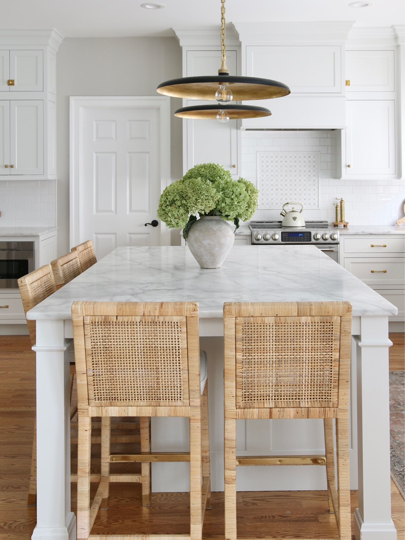 A full view of my kitchen island. We have most of our meals here so it was important to be functional and comfortable. 
The Piatto pendants for from Circa Lighting, the counter stools are from Serena and Lily and the vase from Pottery Barn. 
You can’t see it but there is plenty of cabinet storage in the island 

#LTKstyletip #LTKFind #LTKhome