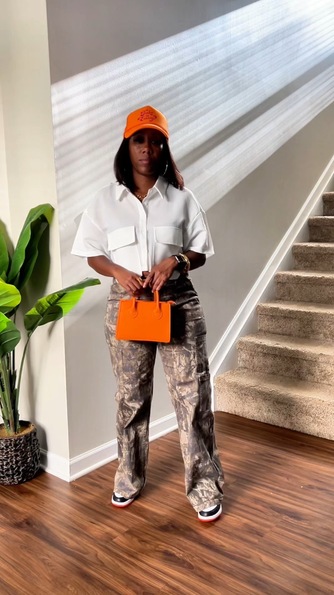 White crop top button up shirt with wood camo wide leg cargo pants accessorized with different color hats and purses.

#LTKPetite #LTKFindsUnder50 #LTKStyleTip