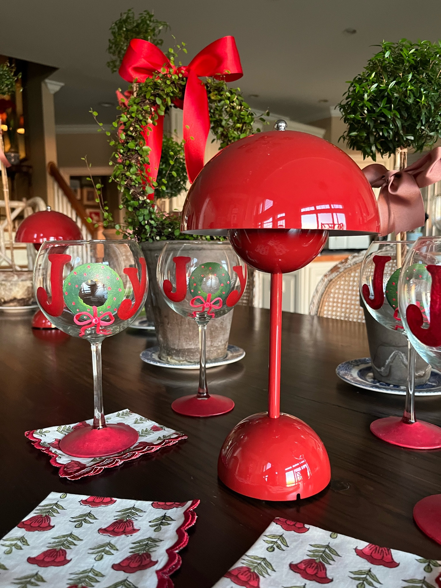 Get holiday party ready with festive Christmas wine glasses, a red battery lamp, red and green napkins and some pretty topiaries! 

#LTKSeasonal #LTKparties #LTKHoliday