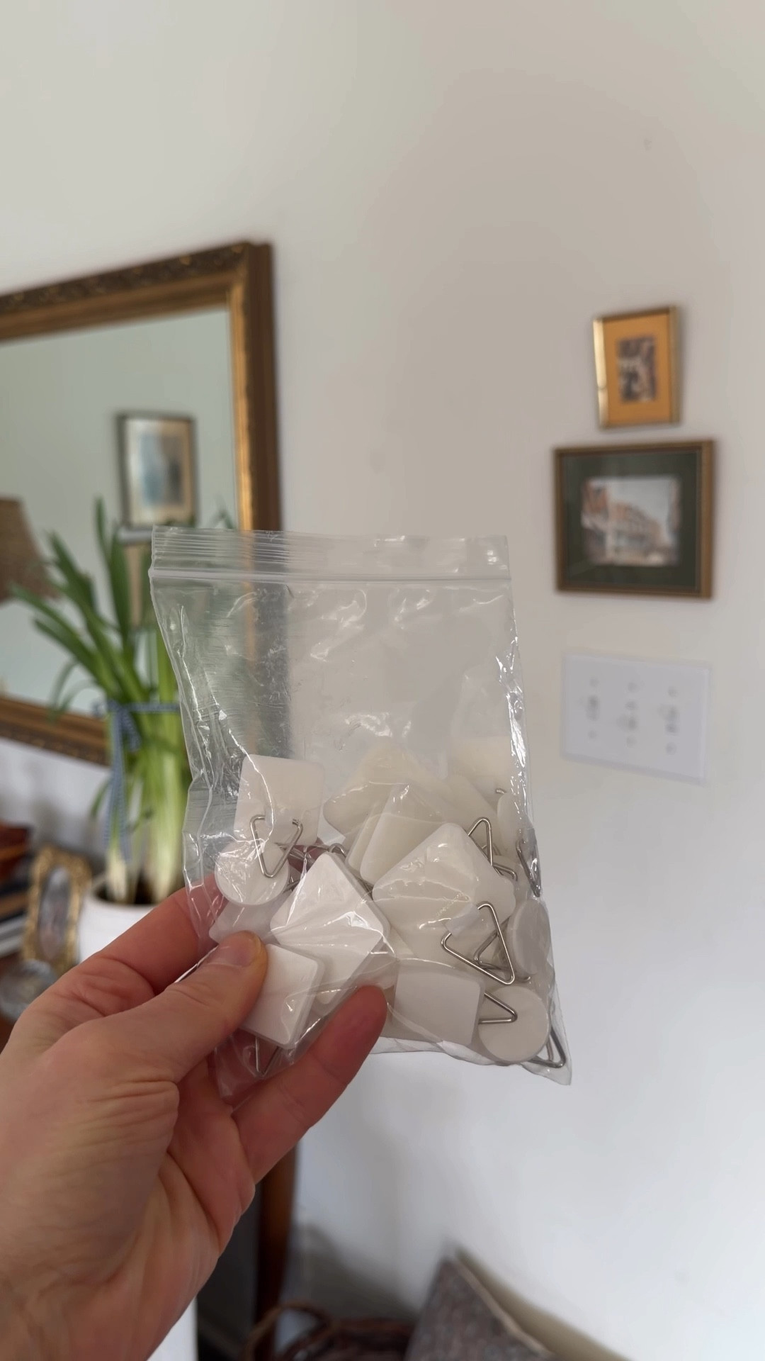 Have you ever wanted to hang something that didn’t have a hook on the back? These little adhesive hangers are so helpful. I cut a piece of cardboard to attach mine to.

#LTKHome