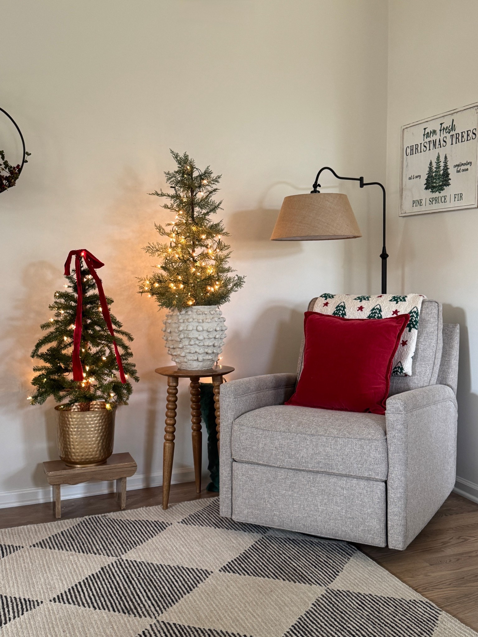 Cozy Christmas corner. My new favorite 2” red frayed soft velvet ribbon, Christmas trees, my favorite accent table, recliner/swivel chair, beige and charcoal area rug currently on sale, cream knot vase and tree sign similar to mine, velvet pillow cover, brass planter. Very similar and better priced floor lamp - the lamp I have linked is a 67'' Dimmable Arched Floor Lamp with Remote Control and is on sale for only $61.99!

#LTKStyleTip #LTKHome #LTKSaleAlert