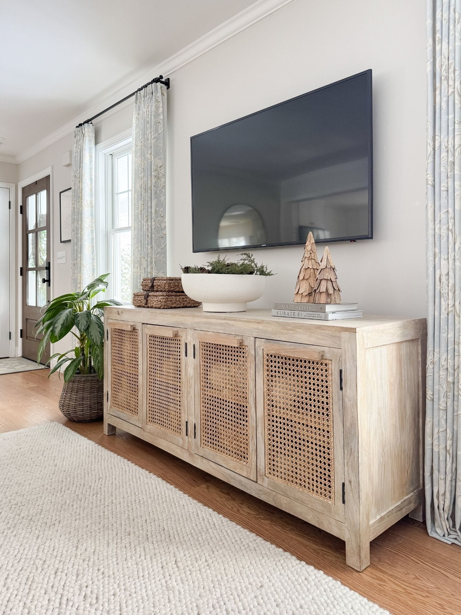 Media console styling! A neutral living room styled with a warm wood console, textured decor, and simple coastal accents. Neutral media console, coastal living room decor, warm wood furniture, cane cabinet styling, coastal neutral home, timeless living room design, Sherri calnan home

#LTKSeasonal #LTKHome