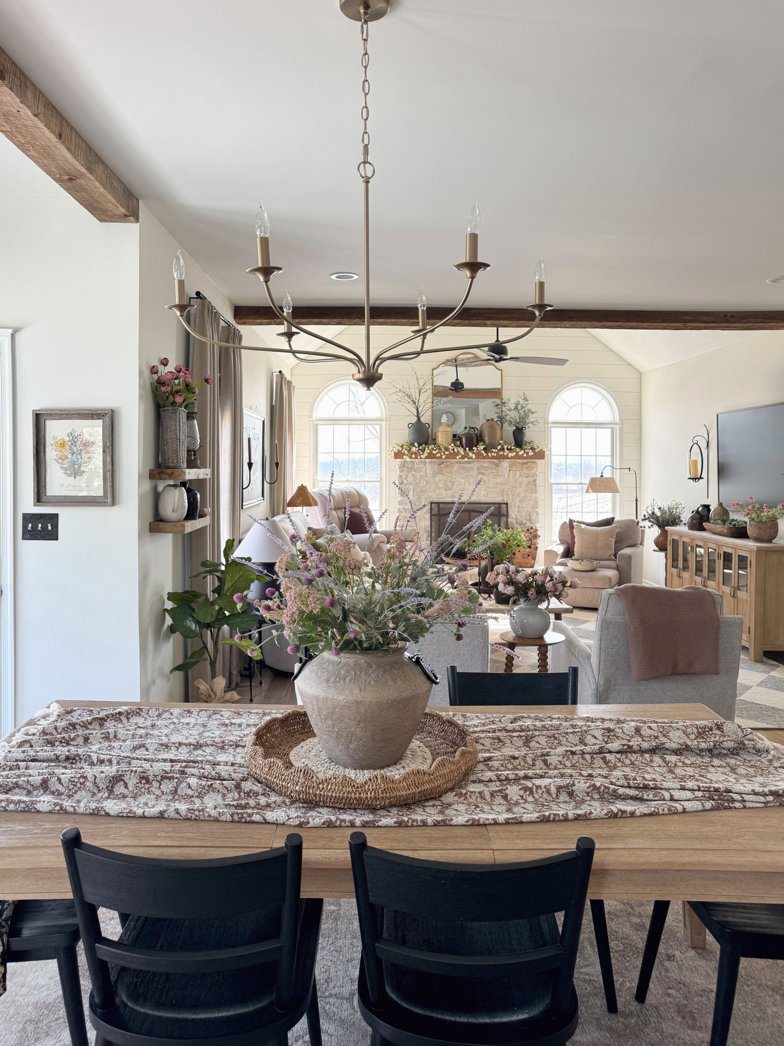 Faux florals to make similar arrangement 
6 arm brushed gold chandelier
Neutral floral throw used for table runner 
Solid wood dining table 
Black wooden dining chairs 
Similar round woven trays



#LTKSpringSale #LTKHome