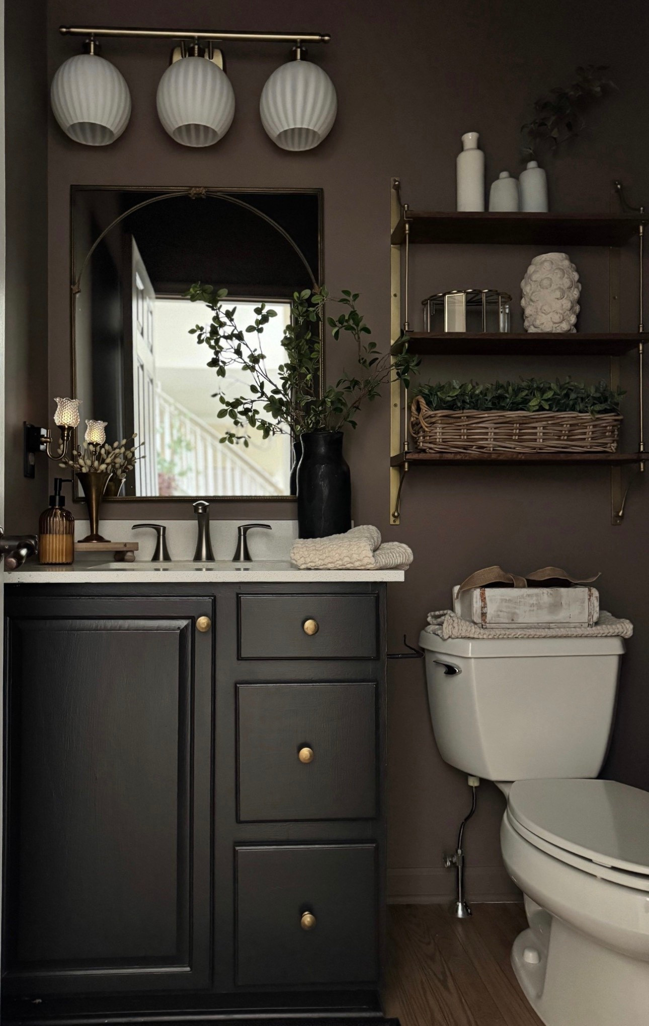 Powder room refresh!

Vanity light in brushed brass with rounded ribbed globes! Currently on sale! 

Triple Parker Wall Shelf. 

The prettiest glass dimmable night light. 

Glass ribbed soap dispenser. 

Trio of small white vases. 

Waffle towels. 

Similar mirror. 

Similar black vase and decor. 

Rub N’ Buff for hardware  
