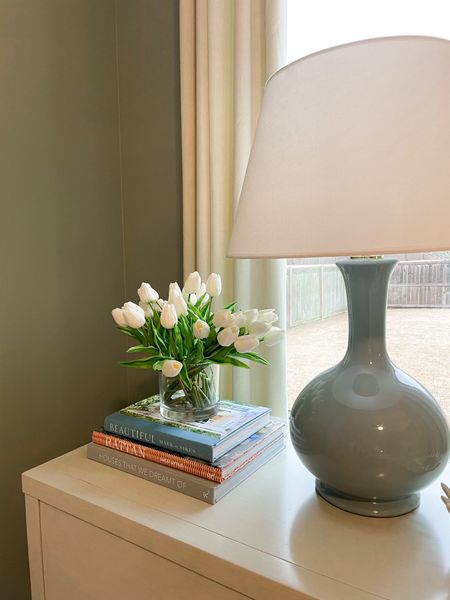 8x8 glass vase with 2 packs of faux tulips from Amazon. Might consider getting a third pack! Coffee table books and nightstand styling books. Gourd lamp from ballard in French blue large size. #masterbedroom #bedroomdecor #amazonhome 

#LTKhome #LTKunder50 #LTKFind