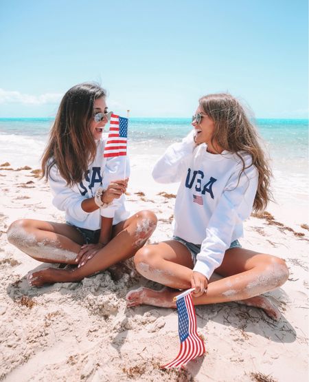 Memorial Day outfit!!! 🇺🇸 

USA sweatshirt, patriotic outfit, denim shorts, mini American flag, Agolde denim, Ray-Ban sunglasses 