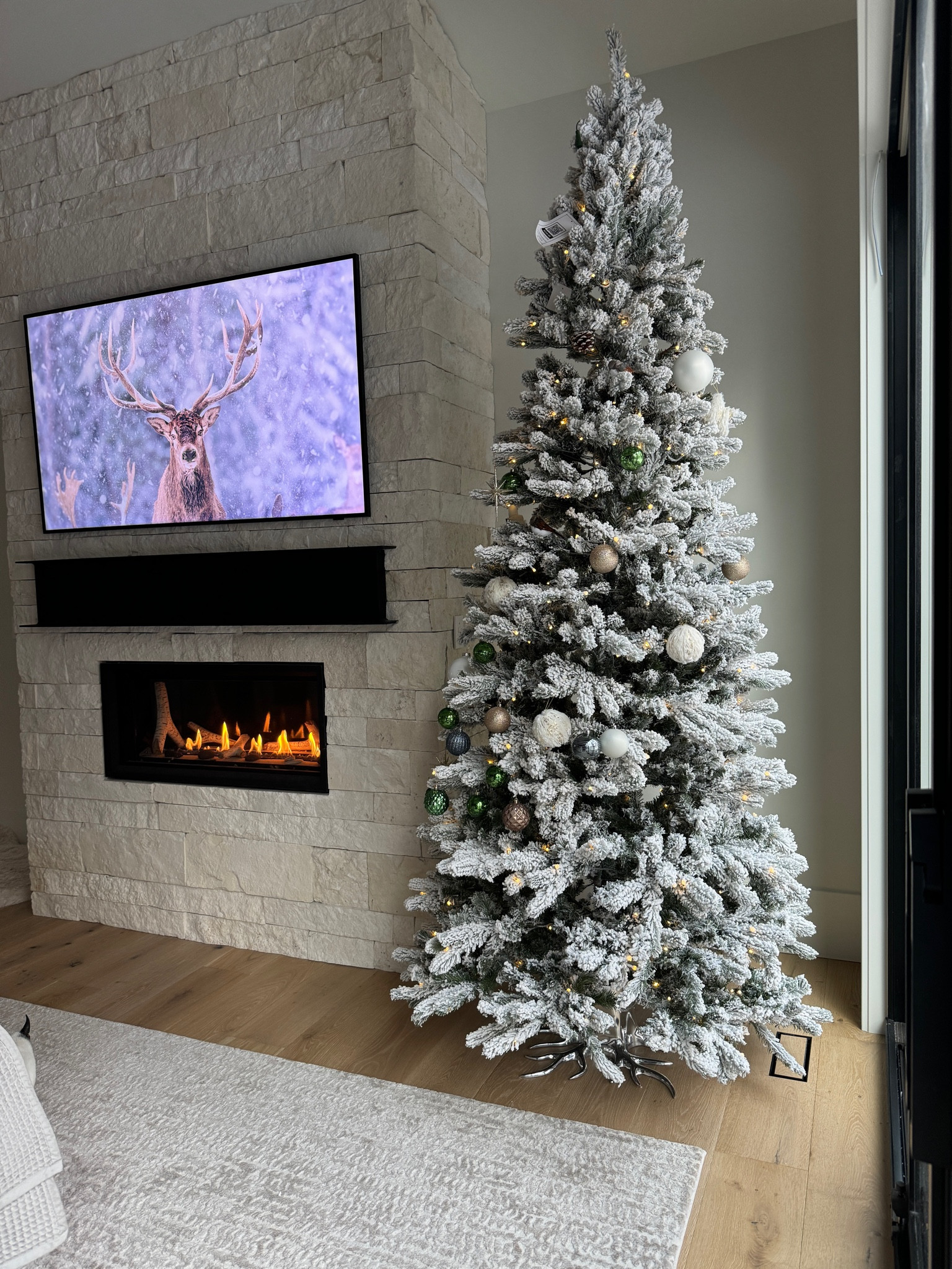 Our 9ft King of Christmas Flocked tree.  This is a 65” Frame TV. 

#LTKHoliday #LTKhome #LTKSeasonal