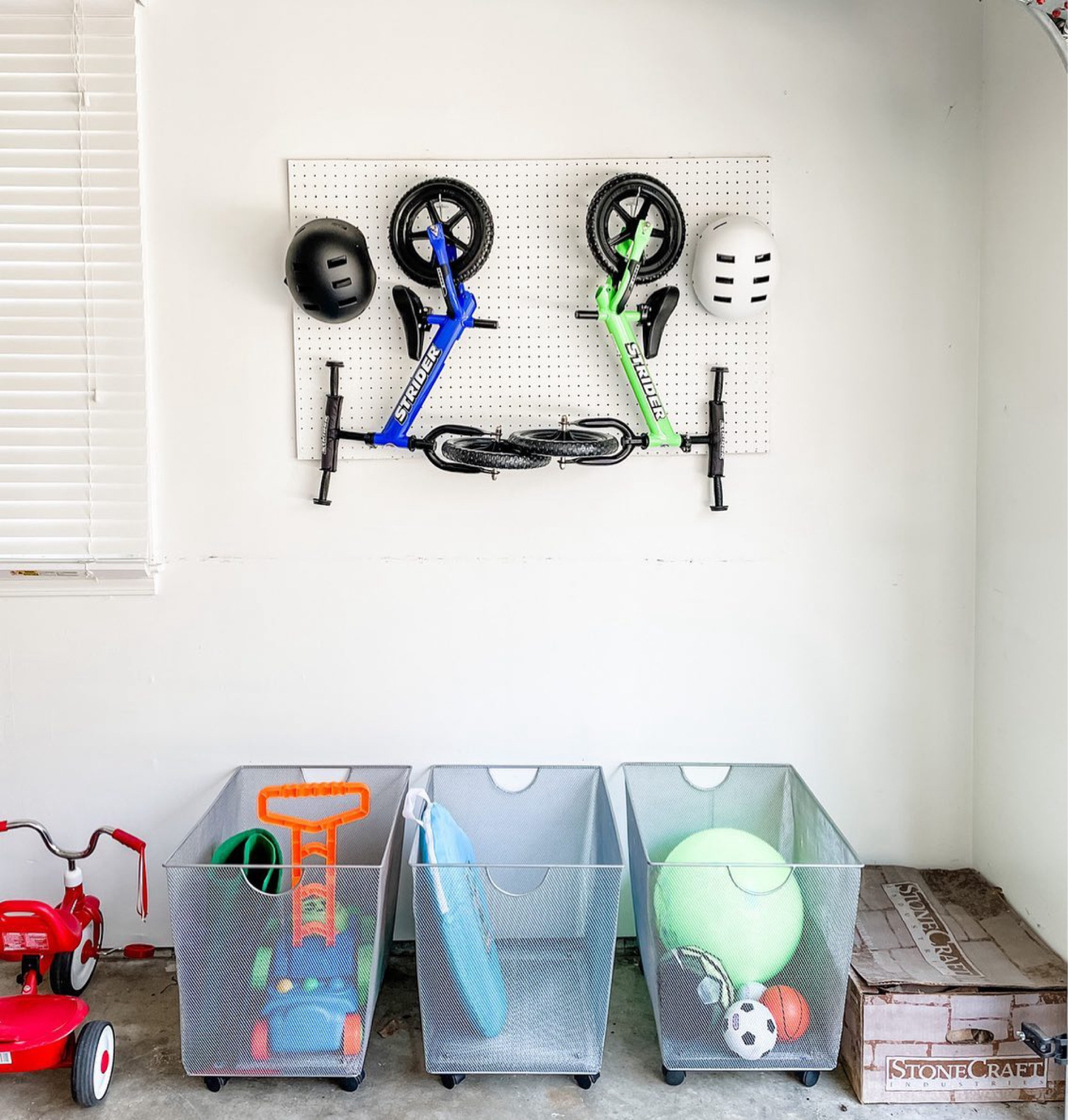 I’m afraid to show you the rest of my garage right now (might be my Saturday organizing project 🤔), but this little nook has me pretty excited! 
•
Have the toys and wheels and bikes and bubbles taken over your garage yet? How are you managing the madness??