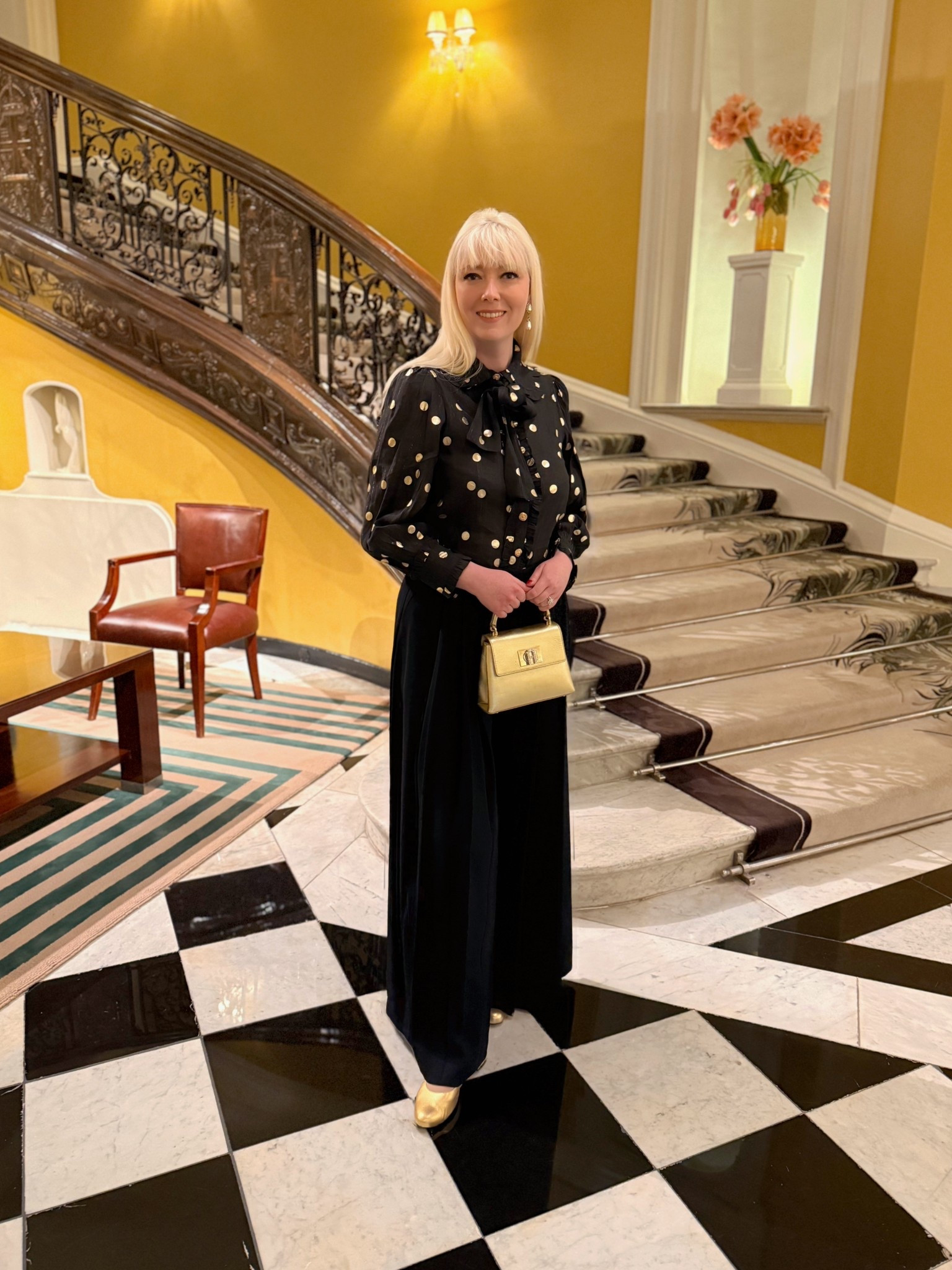 If spring yellow isn’t your thing - wear gold! This look is inspired by Ginger Rodgers and the golden days of the 1930s in Hollywood. I partnered my new (sale purchase) Boden ‘Regent’ glamorous vintage inspired super wide leg black trousers - they almost look like a maxi skirt - with a past Sister Jane gold foil polka dot / spot tie neck blouse (see ideas), Augusta gold Mary Janes from Smallable and a gold Furla 1927 top handle bag 🖤💛🖤

#LTKeurope #LTKsale #LTKspring