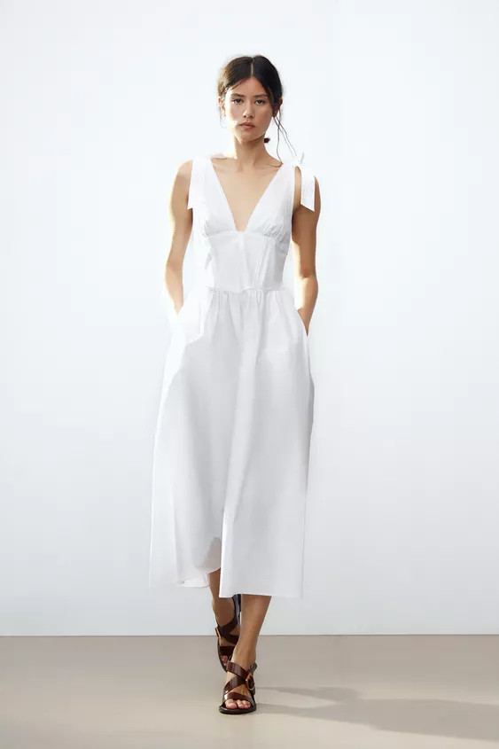 Midi dress made of 100% cotton yarn. Deep V-neckline with tonal lace trim. Adjustable wide straps... | Zara US