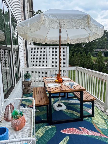 Boho porch decor, patio ideas, fringe umbrella, picnic table, outdoor decorations, boho aesthetic, palm leaf rug, outdoor rug, outdoor furniture 

#LTKhome #LTKSeasonal #LTKxPrimeDay