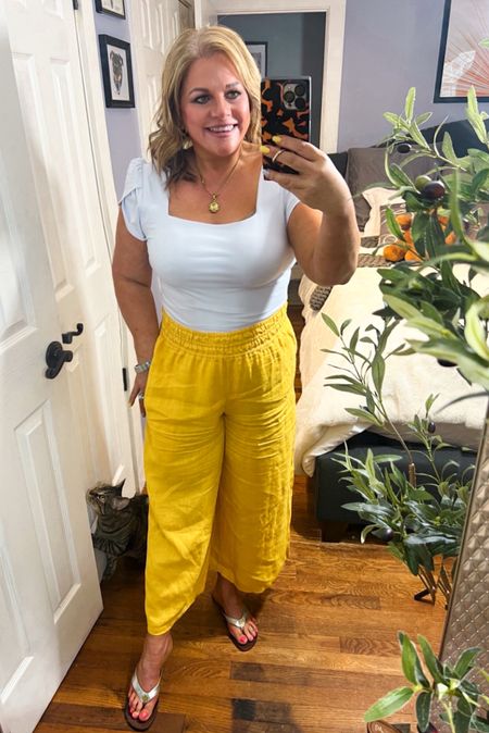 Guys! These are the most comfortable, fun pants ever. They are pure linen, so you’ll easily be forgiven when they wrinkle. These make for the perfect travel outfit, work outfit, vacation outfit or a random summer day outfit! They run true to size. Wearing a petite medium here.
Also, this bodysuit is a dupe for one from Express…only this one is half the cost. This also fits true to size. 
PS: look at my adorable closet raider! 😻😉
Sandals, bodysuits, Anthropologie, Tory Burch, yellow 

#LTKover40 #LTKSeasonal #LTKFestival