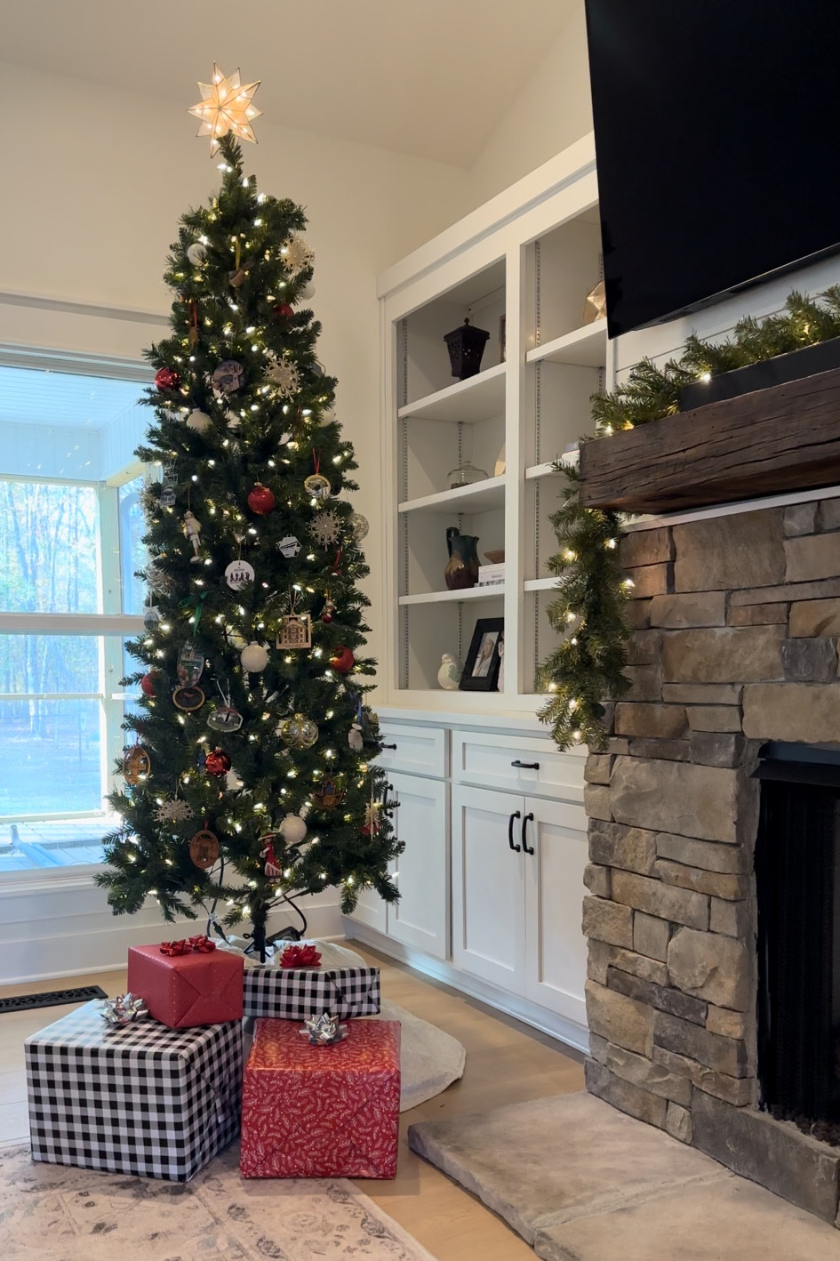 Our 7.5 foot Christmas tree and garland on the mantel.  This tree saves space since it is a slender size!

#LTKHoliday #LTKHome #LTKSeasonal