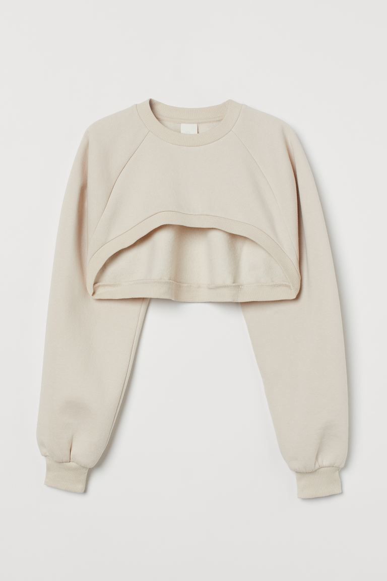 Crop sweatshirt in cotton-blend fabric with soft, brushed inside. Asymmetric cut at front. Crew n... | H&M (US + CA)