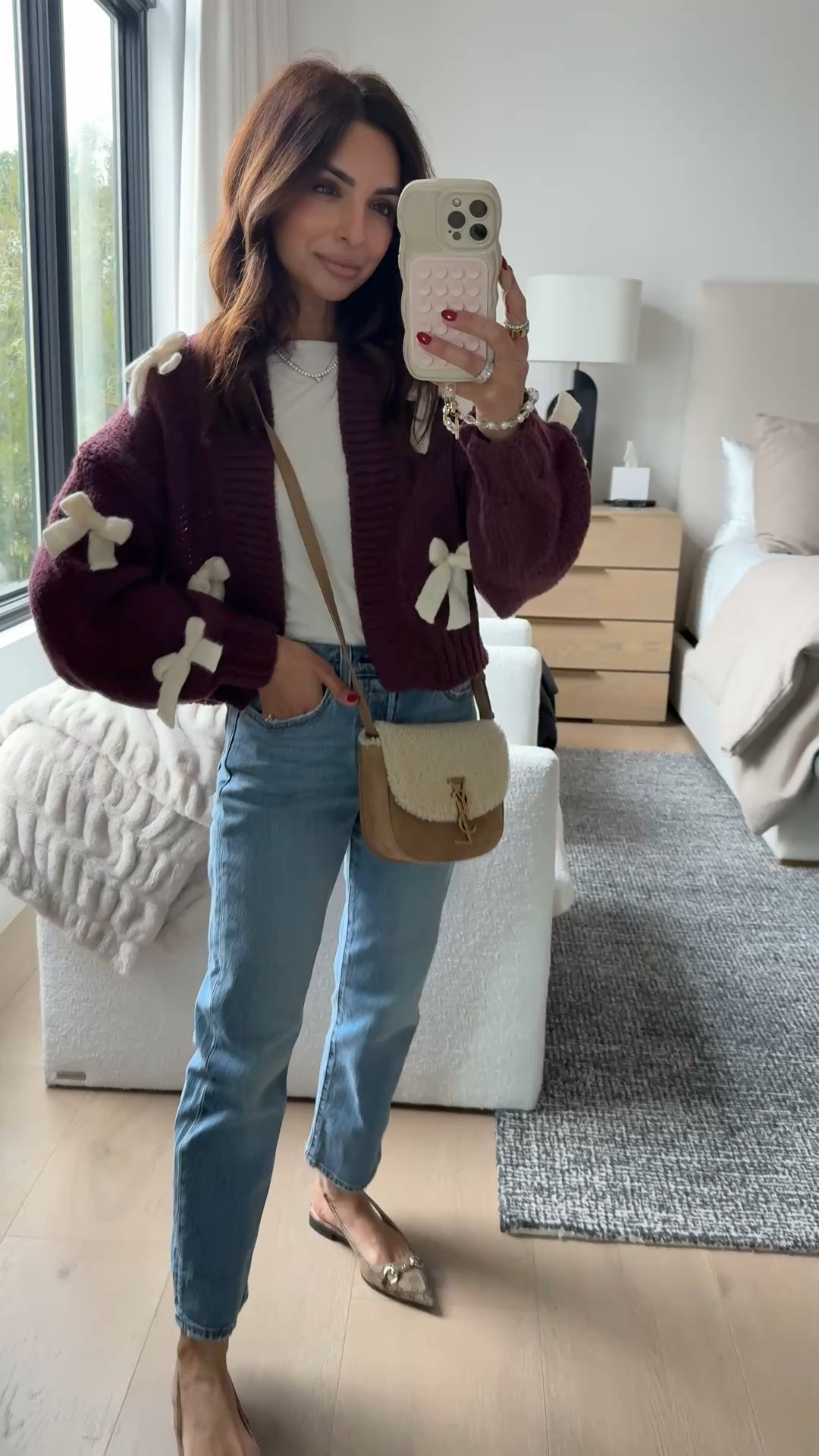 How cute is this bow cardigan from Anthropologie?! Perfect for any casual Holiday party or Christmas dinner! Comes in tan with red bows as well 🤍 

#LTKSeasonal #LTKHoliday