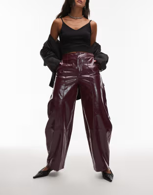 ASOS DESIGN faux leather barrel leg pants with tab detail in burgundy | ASOS (Global)