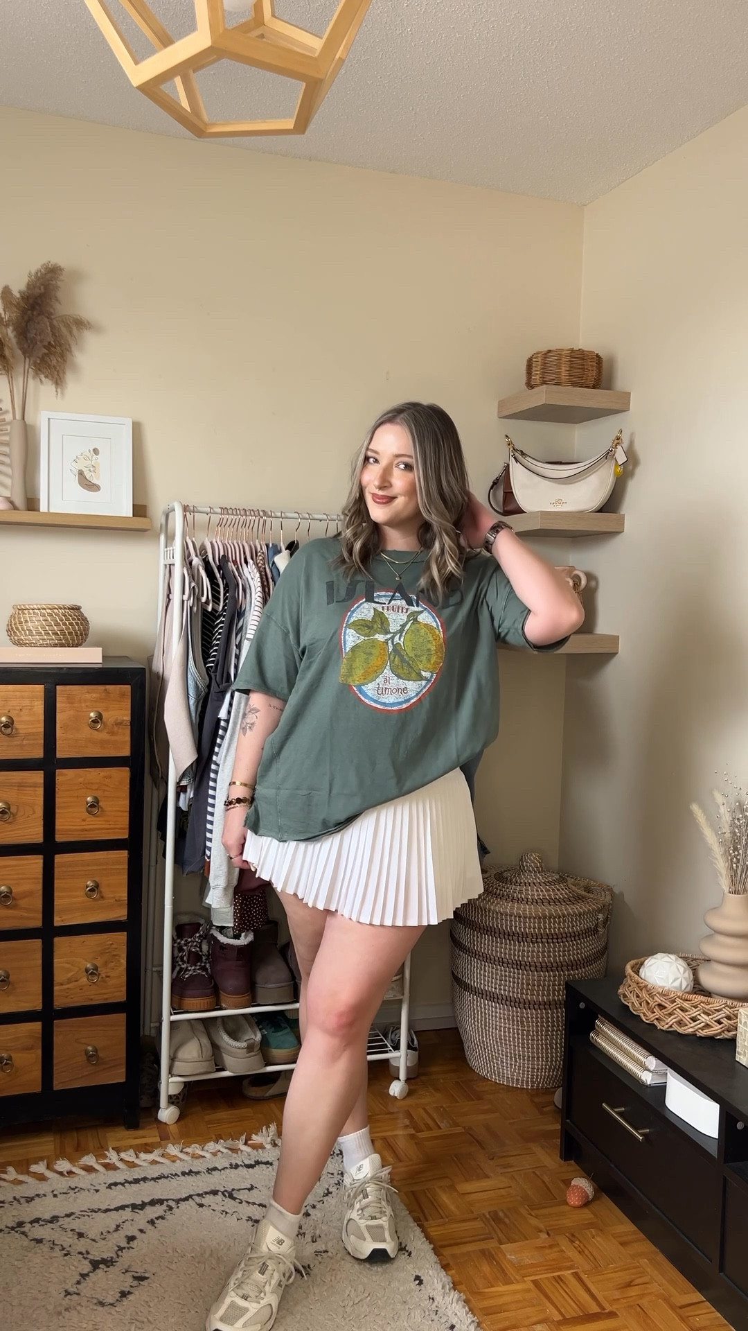 Casual spring to summer outfit on sale! Wearing my usual size L in the graphic tee. Wearing M in the white tennis skirt, I bought it years ago & if I was ordering now I’d get L although M still fits. New Balance sneakers run a little big, I’m a 9.5-10 and wear a 9

#LTKmidsize #LTKsummer #LTKsale