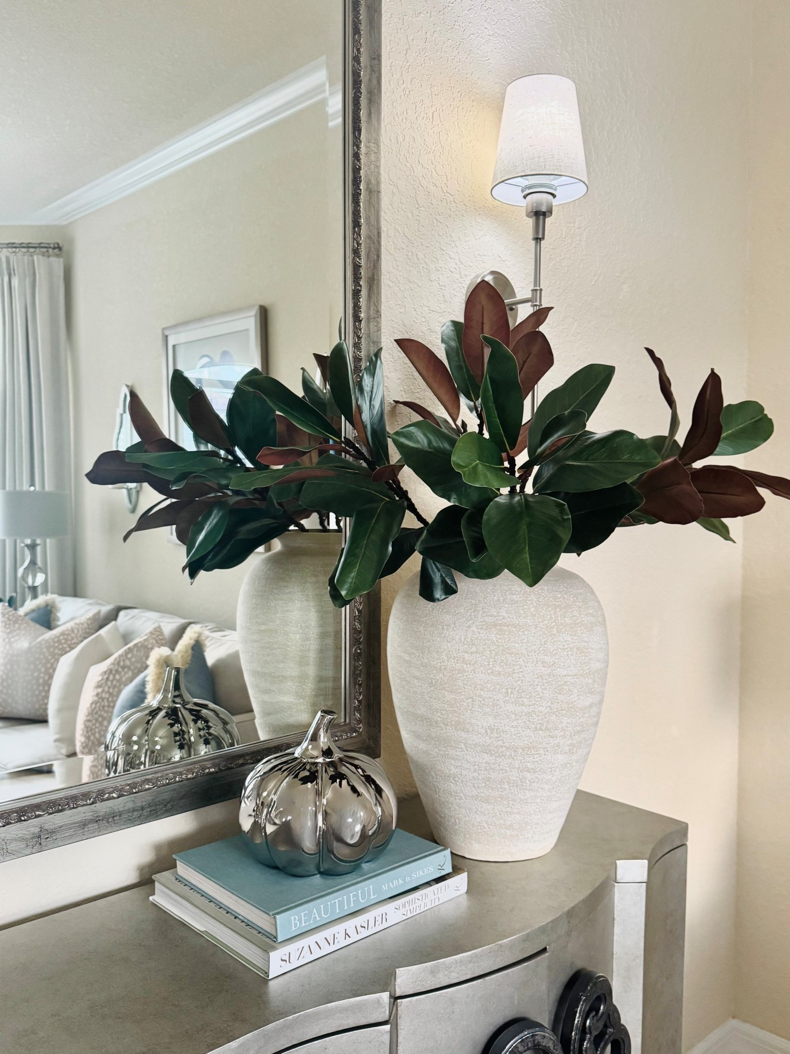 Early fall decor in our formal living room, with touches of blue, faux & fresh Magnolia branches, silver accessories, and gorgeous coffee table books!🩵🍂🍃

Home Decor | Fall Decor | Coffee Table Books | Faux Magnolia Stems | Large Vase | Wall Sconces | Silver Pumpkins | Neutral Decor | Transitional Decor | Modern Decor 

#LTKSeasonal #LTKHome #LTKStyleTip