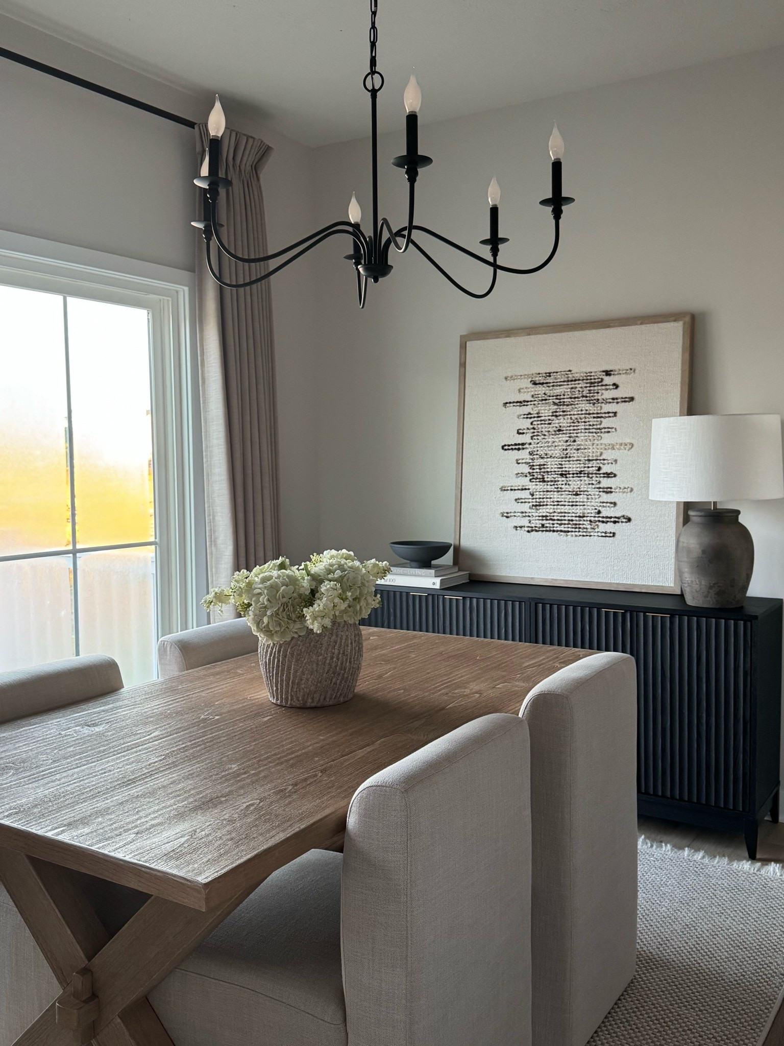 Dining room, sideboard, fluted sideboard, art, amber Lewis art, Getty art, upholstered chairs, dining chairs, cream dining chairs, brown lamp, arrays lamp, wood table, dining room table, cream rug, concrete vase, floral arrangement, dining table styling, chandelier

#LTKSaleAlert #LTKHome #LTKMidsize