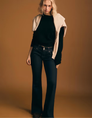 Stradivarius Low-rise bell bottom jeans with two metal buttons in rinse blue denim | ASOS (Global)