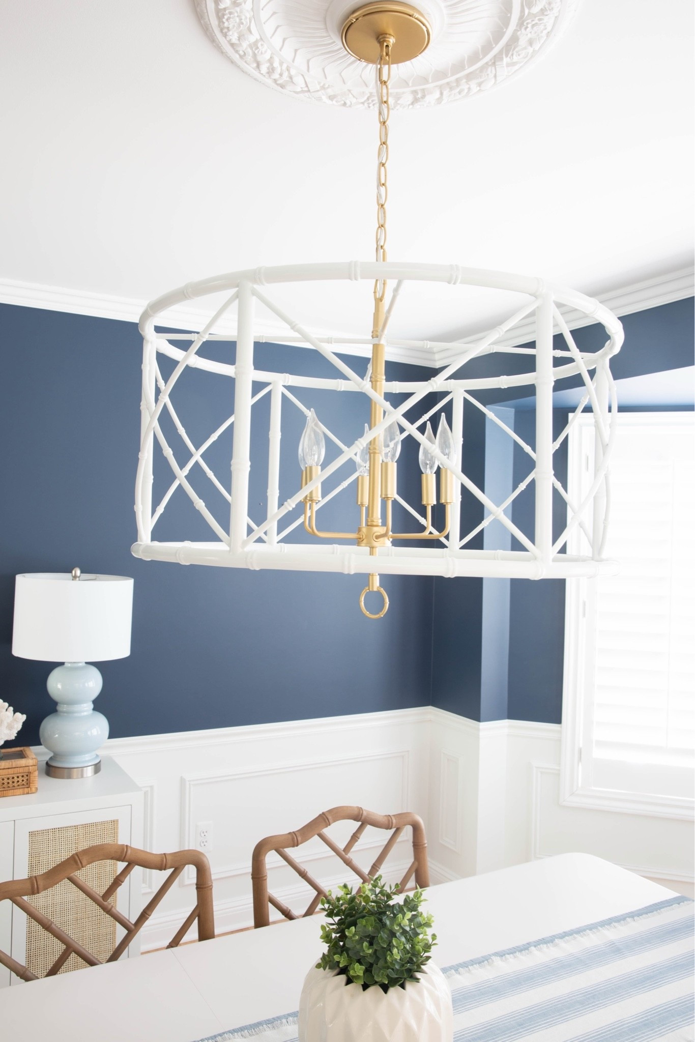 This white bamboo chandelier is the statement piece in my coastal dining room, adding natural texture and effortless coastal style. I love how it softens the space and pairs perfectly with blue and white decor for a bright, designer-inspired look.

#LTKHome #LTKSaleAlert #LTKU