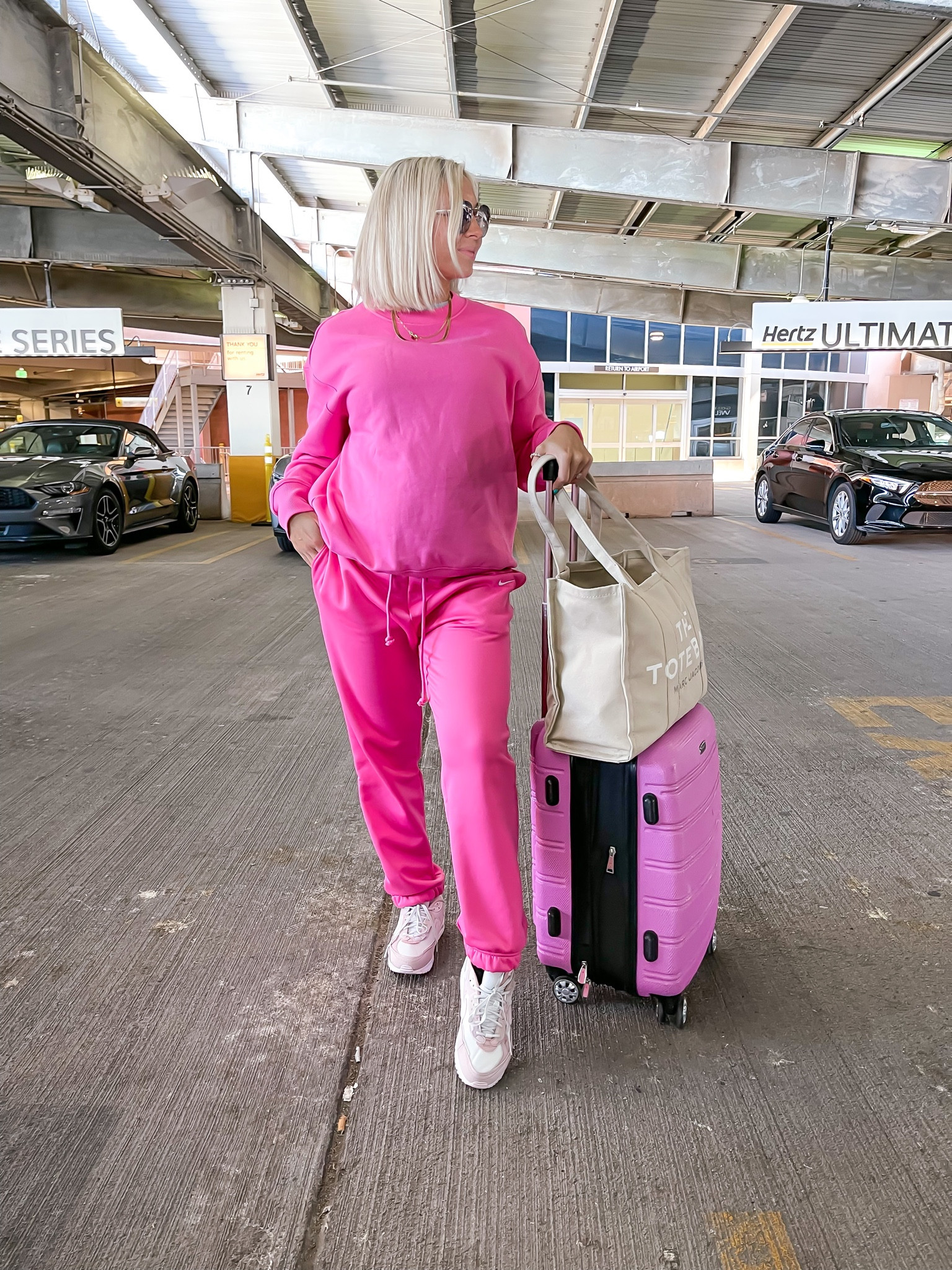 Pink #traveloutfit — Nike pullover (small) + sweats (medium) are the perfect combo for a stylish, comfort outfit! #suitcase #travel #nike 

#LTKunder100 #LTKtravel #LTKstyletip